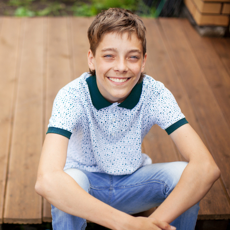 Smiling teen outdoors at summer. Happy one boyの写真素材