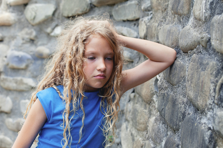 Sad child outdoors. Unhappy teenager. Abuseの写真素材