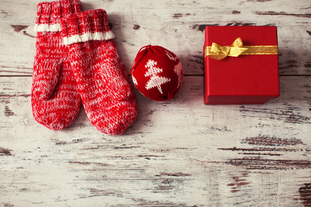Mitten with christmas ball on wood floor. Winter decorationの写真素材