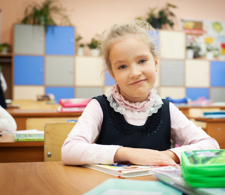 Girl at classroom. Children at schoolの写真素材