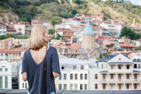 Woman tourist looking at the panorama of Tbilisiの写真素材