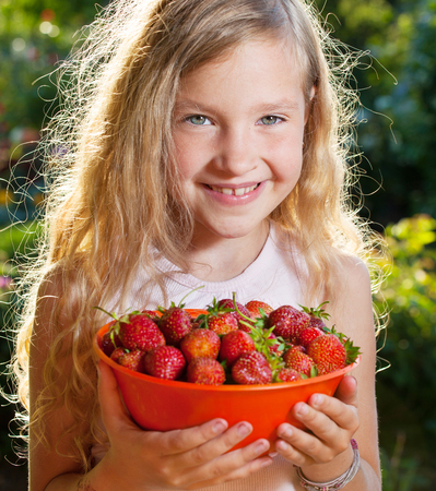 Child with strawberryの写真素材
