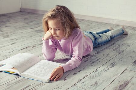 Child reading bookの写真素材