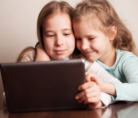 Children playing on tablet. Kids looking at computerの写真素材