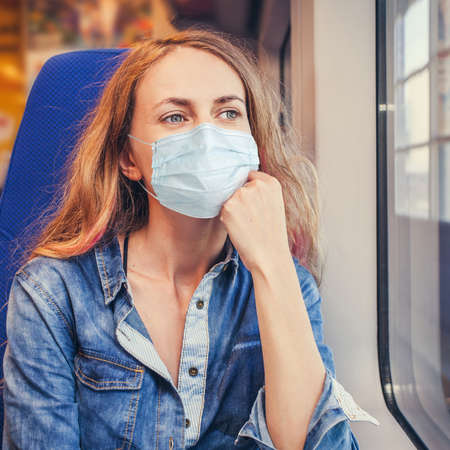 Coronavirus, quarantine. Woman traveling by pablic transport. Beautiful young female travelling in a...