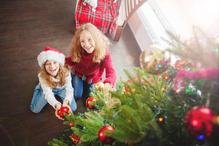 Children decoration christmas tree. Little girl at home. Happy New Year!の写真素材