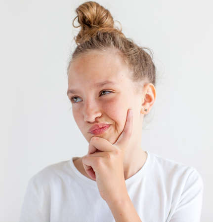 Portrait smiling thinking young girl. Teen at white background