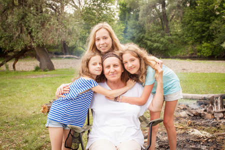 Portrait of a grandmother with grandchildren. Big family Senior with children outdoor at park