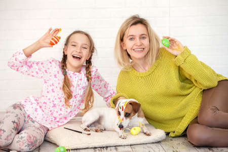 Mom and child decorate Easter eggs. family at home. woman with girl painting