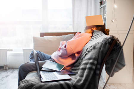 Unhappy teen girl during home online education using laptop. Stress sadness female student do homework classes. Sad woman work remote from homeの写真素材
