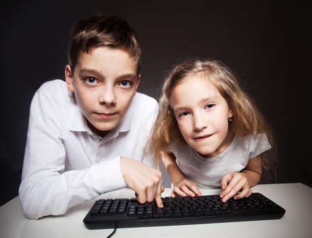 Children looking at a computer. computer addictionの写真素材