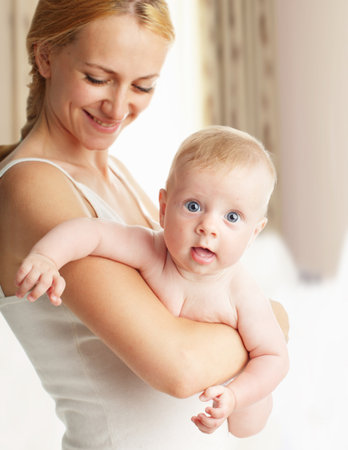 mother with baby at home. Happy family with newborn indoorsの写真素材