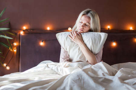 Upset distressed middle aged woman sit on floor in bedroom cry having emotional personal problems breakup or divorce, depressed sad female feel down stressed suffer from infertility or depression at homeの写真素材