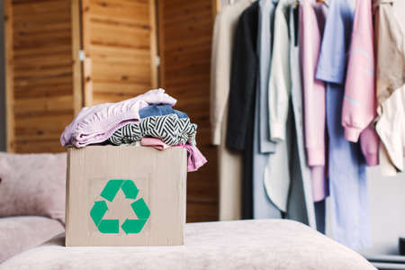 cardboard recycling box with clothes at home