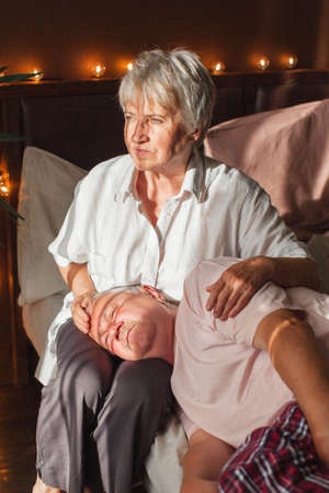 Upset elder wife comforting offended hurt senior husband, talking to anxious woman, giving support, empathy, love. Older couple relationships, family problems, elderly ageの写真素材