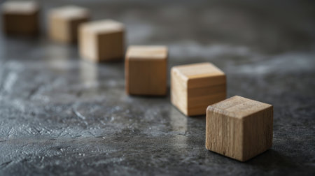 Scattered wooden blocks on a gray surfaceの素材