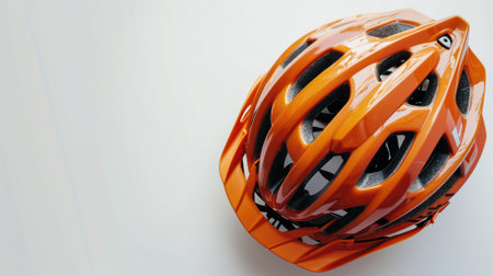 Orange mountain bike helmet on a white backgroundの素材