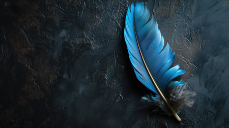 Bright blue feather on a textured black backgroundの素材