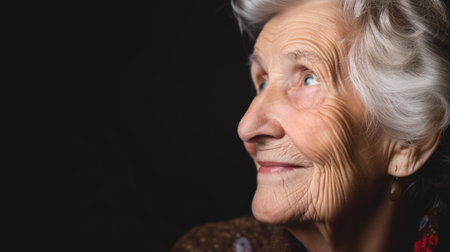 Close-up of a senior woman looking up with a hopeful expressionの素材