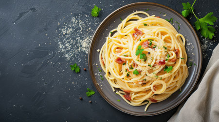Delicious spaghetti carbonara served on a dark plate, garnished with parsleyの素材