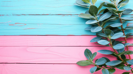 Fresh green leaves arranged on a vibrant pink wooden backgroundの素材