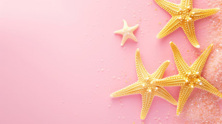 Starfish and sugar crystals scattered on a pastel pink backdropの素材