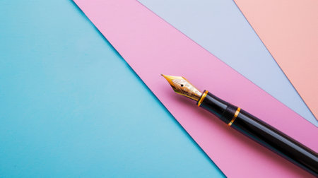 Fountain pen on a split pink and blue background with geometric shapesの素材