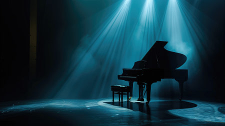 A grand piano awaits its performer on a dark stage, highlighted by a single blue spotlightの素材