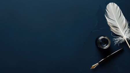 A white quill pen and an inkwell on a dark blue background with ample negative spaceの素材