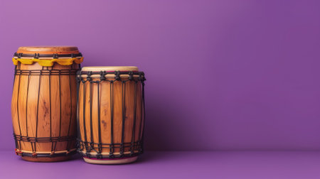 Two wooden djembe drums against purple background with ample space for text on right sideの素材