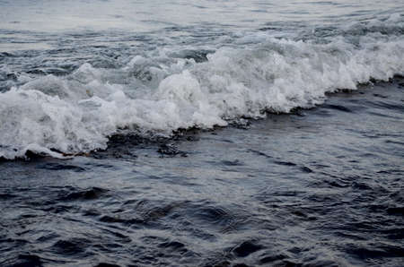 Frothy a tidal wave on the shore alpine lakesの写真素材