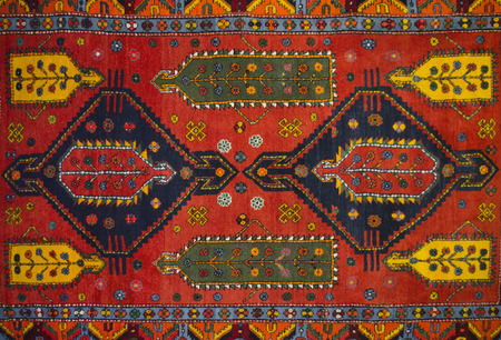 The middle with geometrical pattern ancient Armenian red woolen carpetの写真素材