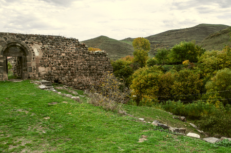 Entrance to the stone wall medieval monastery aboutÃ‚Â garden with yellowed the walnut trees