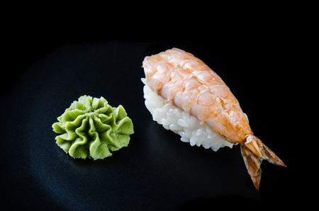 Nigiri sushi made from shrimp, wasabi and japanese rice. Sushi close-up on a black background. Japanese food.の写真素材