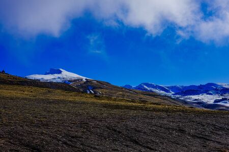 Beautiful landscape snow covered mountains and blue skyの写真素材