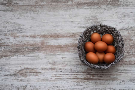 Easter eggs on a gray wooden background. Easter mockup with space for text.