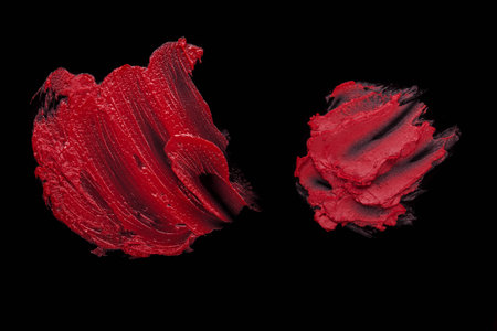 Red lipstick smudged on a black isolated background