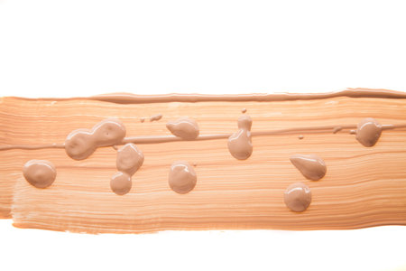 Smudged liquid make-up base isolated on a white background