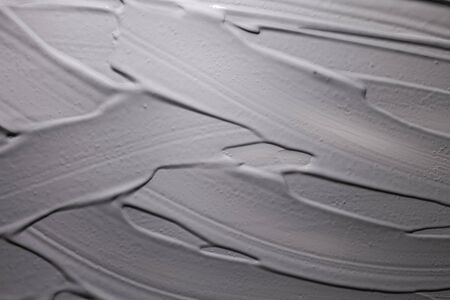 Cosmetic creamy mask charcoal mud clay gray black textured background