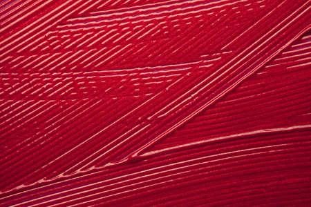Glossy red lipstick background texture smudgedの写真素材