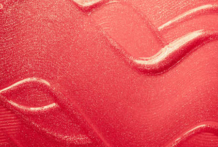 Glossy coral lipstick background texture smudgedの写真素材