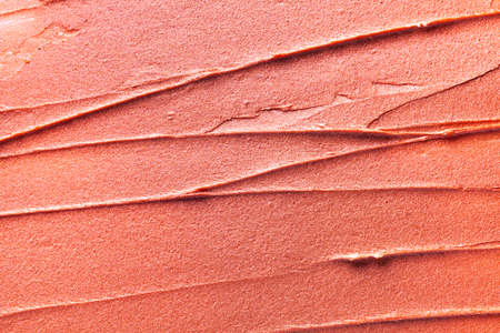 Glossy coral lipstick background texture smudgedの写真素材