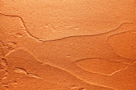 Glossy golden orange lipstick background texture smudgedの写真素材