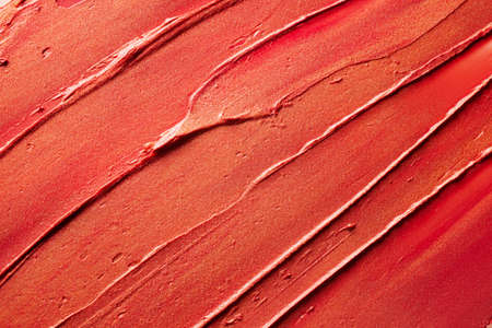 Glossy red lipstick background texture smudgedの写真素材