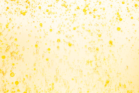 Abstract yellow water splash with bubbles on a white background. Texture.の写真素材