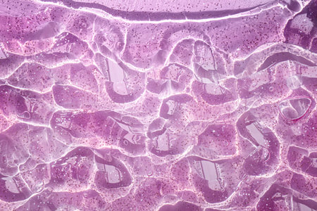 abstract background of rippled pink paint on a glass surfaceの写真素材