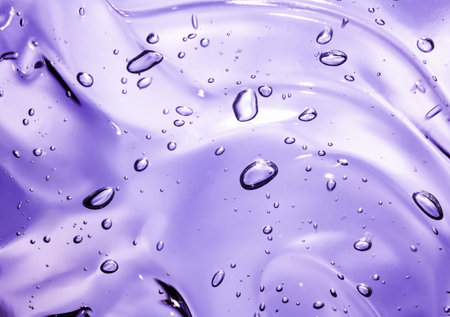 abstract purple background with some smooth lines in it and some water dropsの写真素材