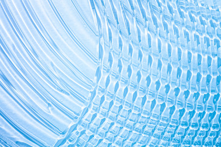 abstract blue background with some smooth lines in it and some reflectionsの写真素材