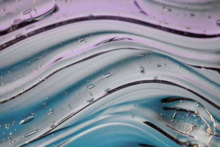 Abstract background with blue and purple liquid. Water drops on the surface.