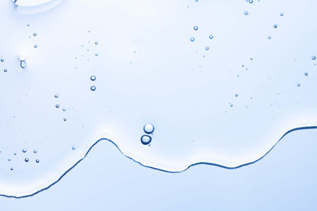 Cream gel gray blue transparent cosmetic sample texture with bubbles blue mirror backgroundの写真素材